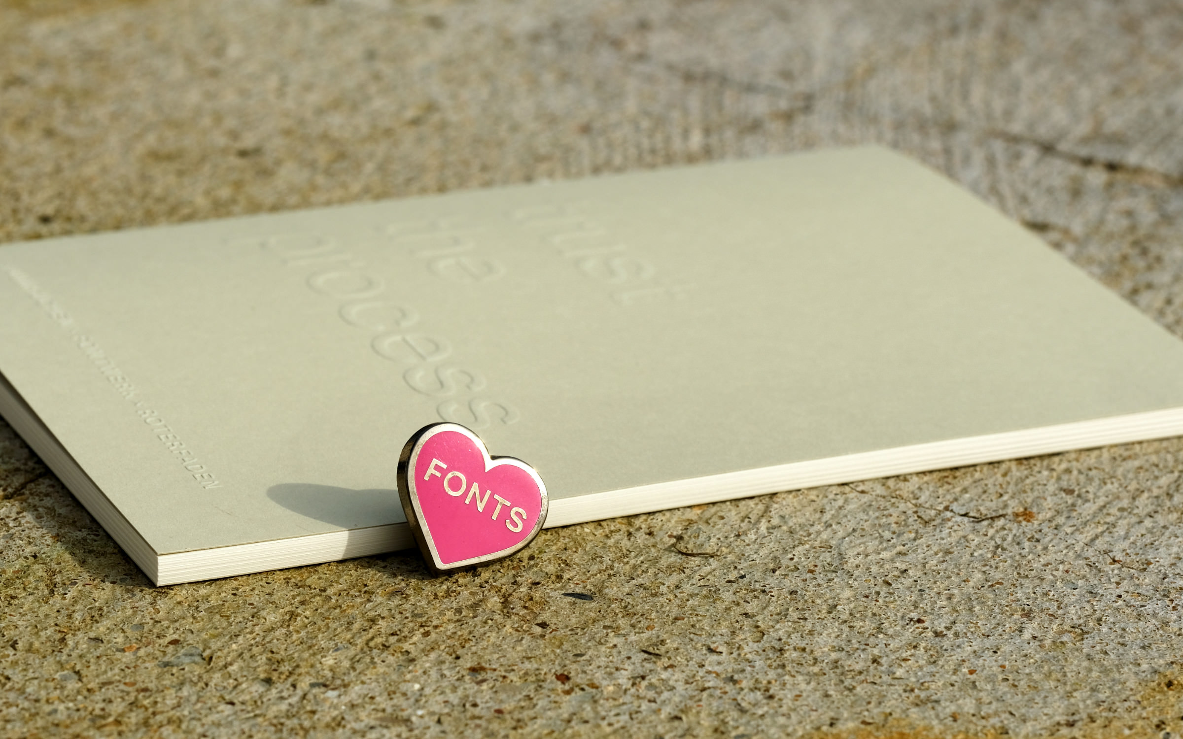 The notebook and the FONTS heart pins, both strictly limited